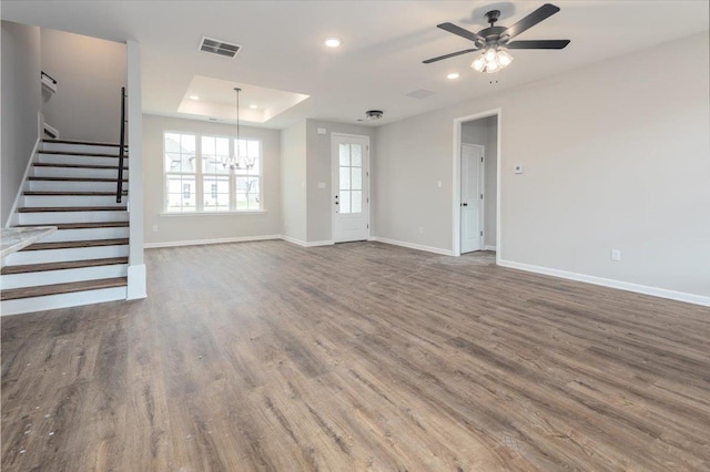 unfurnished living room featuring recessed lighting, baseboards, visible vents, stairs, and wood finished floors