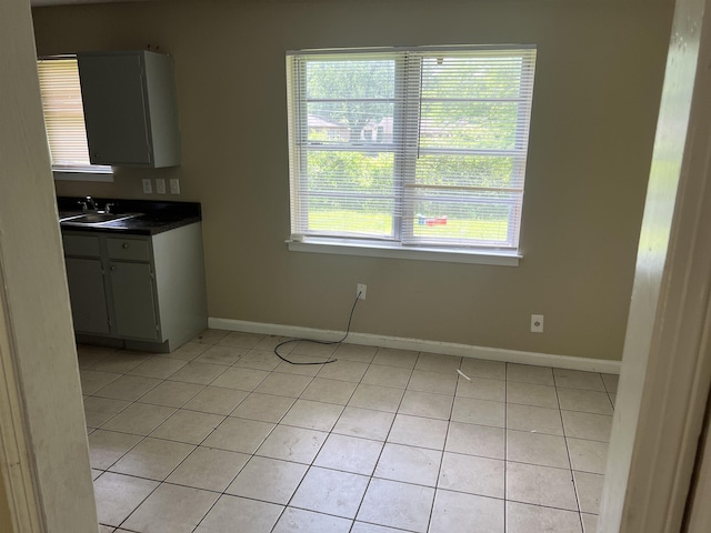 2997 Atmore St, Memphis, TN 38118 - unfurnished dining area featuring baseboards, light tile patterned floors, and a sink