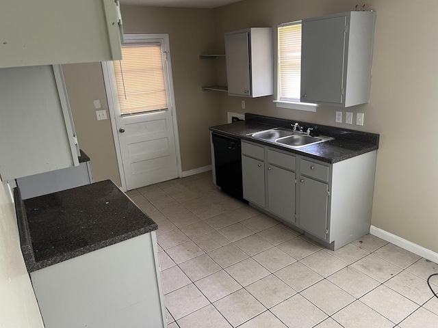 2997 Atmore St, Memphis, TN 38118 - kitchen featuring dishwasher, light tile patterned floors, baseboards, a sink, and dark countertops