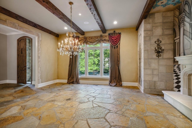 75 Notting Creek Cv, Eads, TN 38028 - unfurnished dining area featuring baseboards, stone floors, an inviting chandelier, and beam ceiling