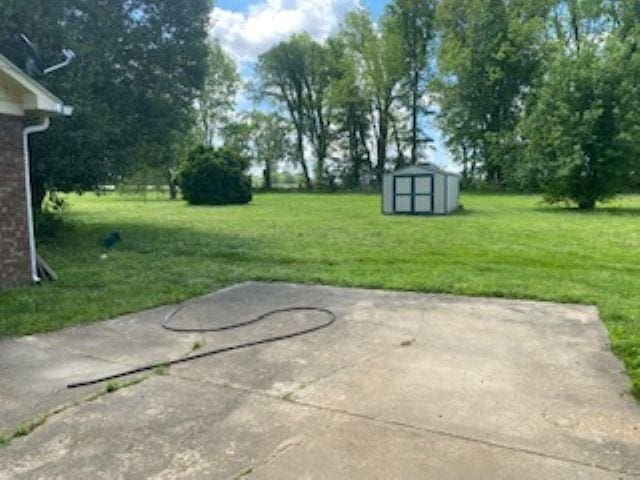 283 Brierhedge Rd, Covington, TN 38019 - view of patio with a shed and an outdoor structure
