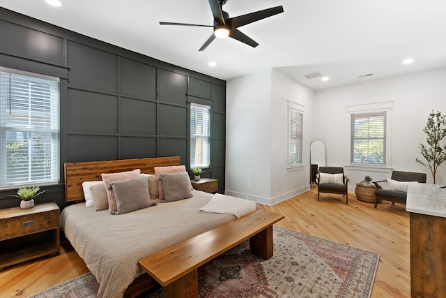 bedroom featuring light wood finished floors, baseboards, visible vents, and recessed lighting