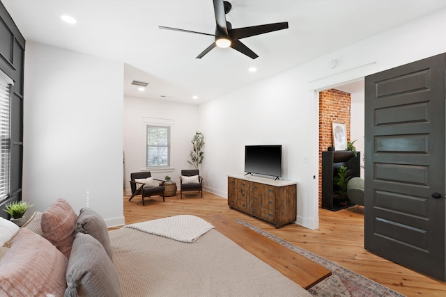 bedroom featuring light wood finished floors, baseboards, visible vents, and recessed lighting
