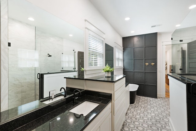 full bath with vanity, visible vents, recessed lighting, a shower stall, and a soaking tub