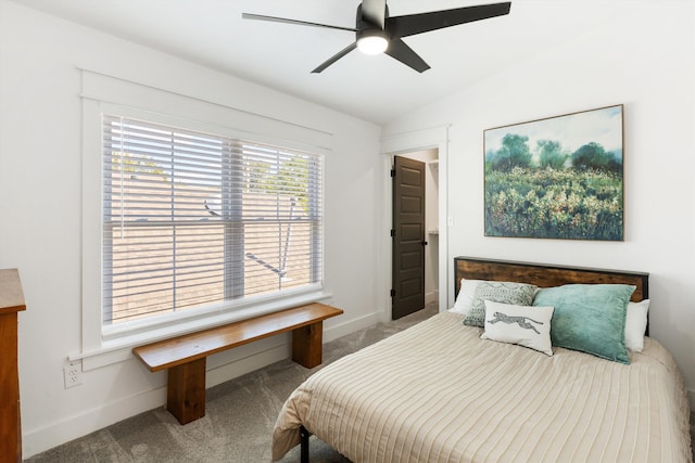 carpeted bedroom with a ceiling fan, baseboards, and lofted ceiling