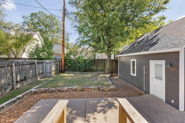 view of yard featuring a patio area and a fenced backyard