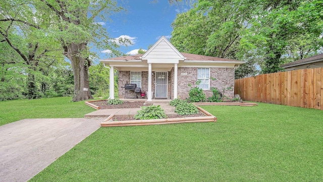 bungalow featuring a front lawn, brick siding, fence, and a porch
