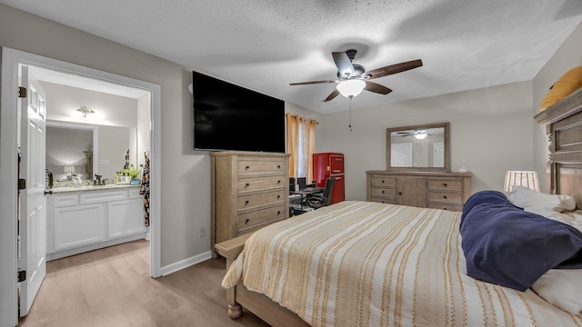 bedroom featuring light wood finished floors, connected bathroom, baseboards, and ceiling fan