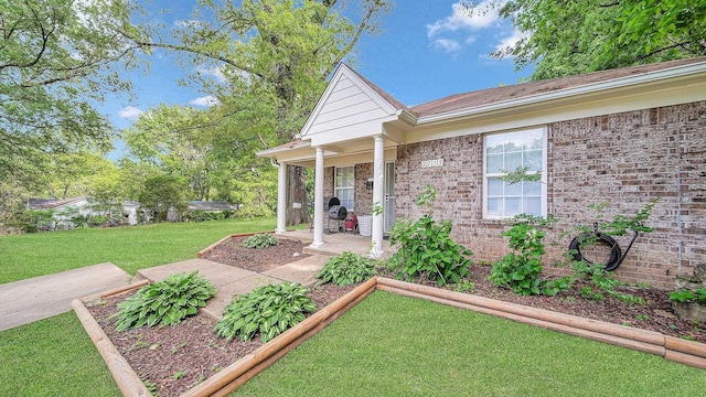 exterior space with a lawn and brick siding