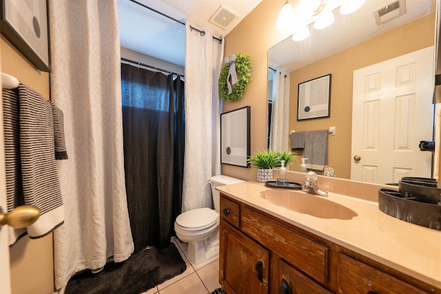 bathroom featuring toilet, visible vents, tile patterned flooring, and vanity