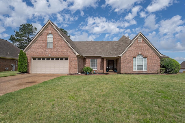 view of front of home with a front lawn, brick siding, driveway, and roof with shingles