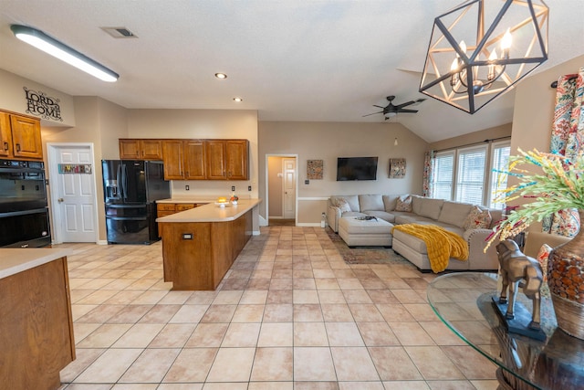 kitchen with brown cabinetry, ceiling fan with notable chandelier, a peninsula, open floor plan, and black appliances