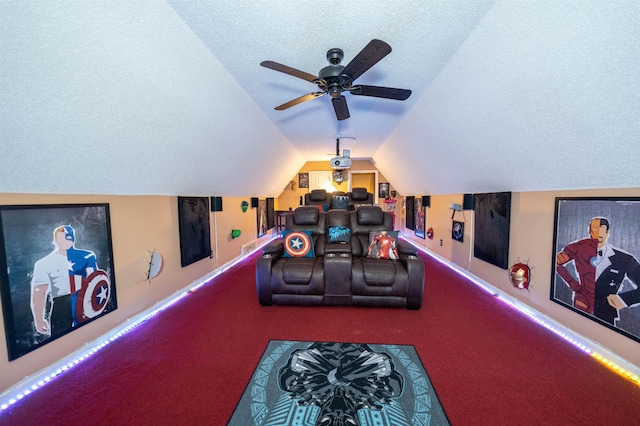 carpeted home theater featuring a ceiling fan, baseboards, a textured ceiling, and vaulted ceiling