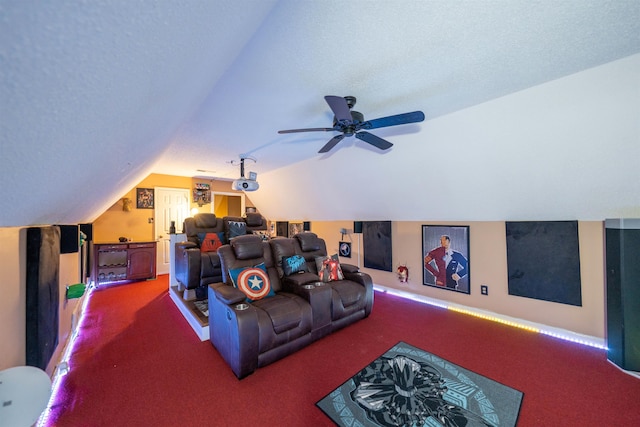 carpeted home theater featuring lofted ceiling and a ceiling fan