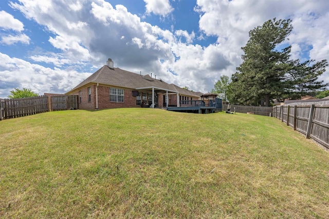 view of yard featuring a wooden deck and a fenced backyard