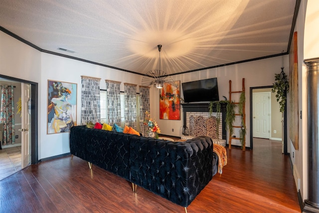 living room featuring ornamental molding, baseboards, visible vents, and wood finished floors