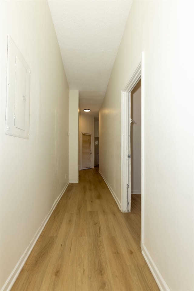 993 Oakview St, Memphis, TN 38114 - hall featuring baseboards, light wood-type flooring, and electric panel