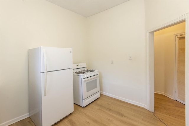 993 Oakview St, Memphis, TN 38114 - kitchen with white appliances, baseboards, and light wood-style floors