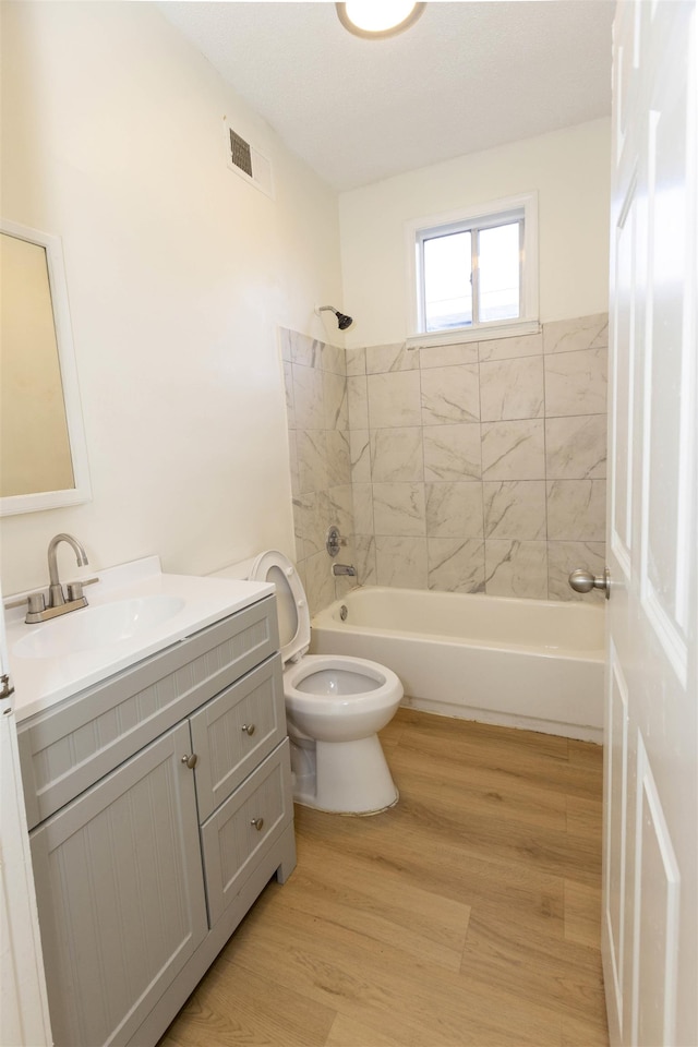 993 Oakview St, Memphis, TN 38114 - full bathroom featuring toilet, wood finished floors, visible vents, vanity, and shower / bathtub combination