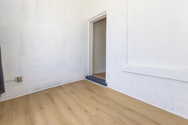 993 Oakview St, Memphis, TN 38114 - spare room featuring brick wall and wood finished floors