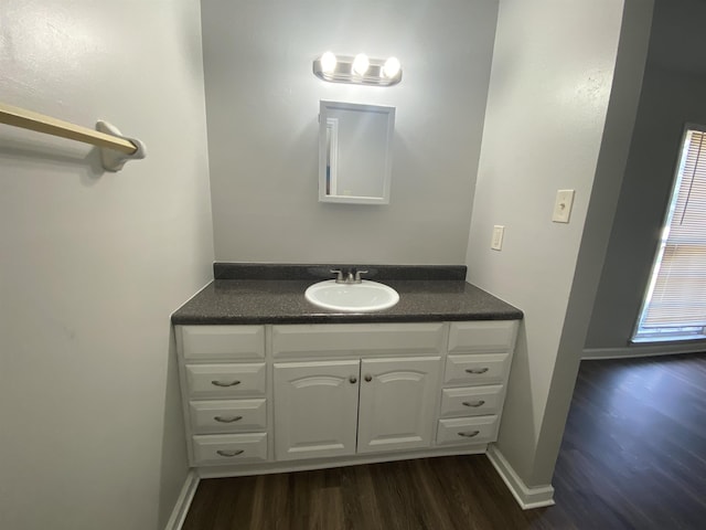 3682 Hyacinth Dr, Memphis, TN 38115 - bathroom with vanity, baseboards, and wood finished floors
