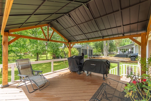 wooden deck with a yard, an outdoor structure, and area for grilling