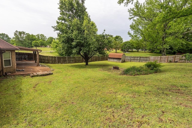 view of yard featuring a fenced backyard, a storage shed, a wooden deck, and an outdoor structure