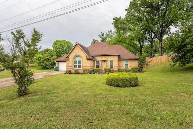 ranch-style house with driveway, brick siding, fence, a garage, and a front yard