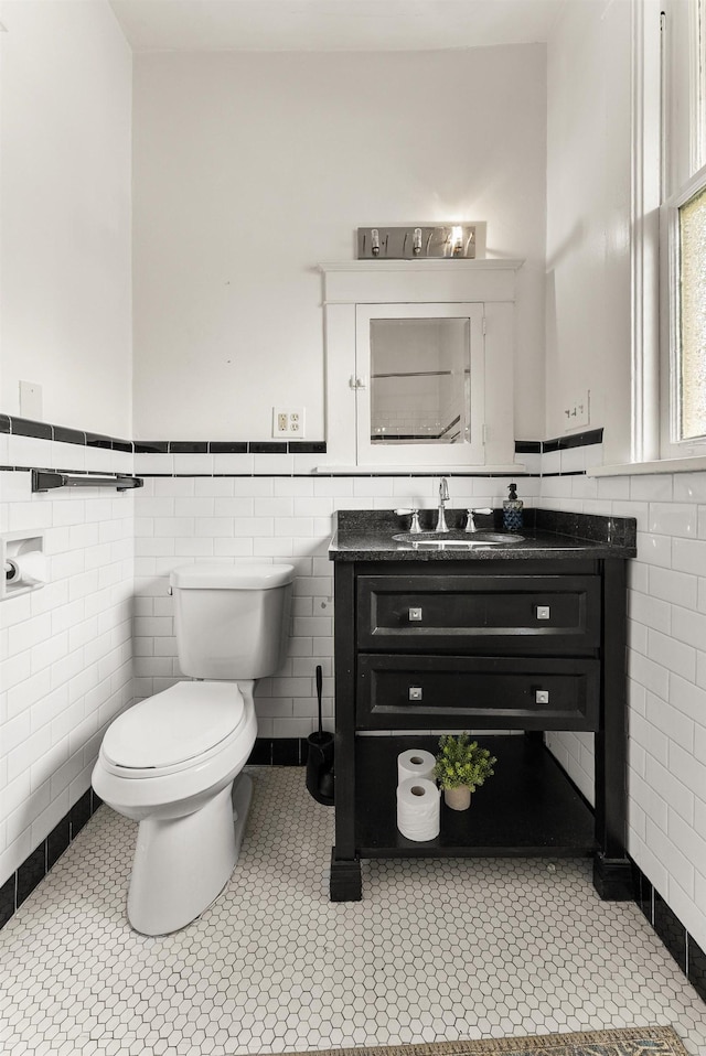 158 N Willett St, Memphis, TN 38104 - bathroom featuring tile walls, toilet, wainscoting, and vanity