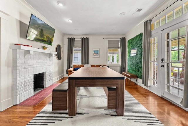 158 N Willett St, Memphis, TN 38104 - dining space featuring crown molding, plenty of natural light, wood finished floors, and a fireplace