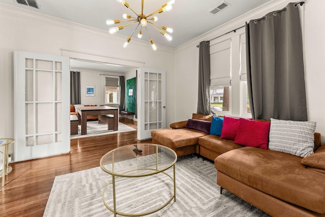 158 N Willett St, Memphis, TN 38104 - living room with french doors, ornamental molding, visible vents, a chandelier, and wood finished floors
