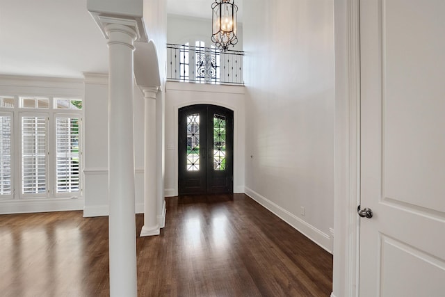 1180 Braywind Dr, Collierville, TN 38017 - entryway featuring a notable chandelier, baseboards, dark wood-type flooring, arched walkways, and ornate columns