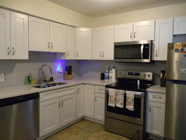 496 Eastern Dr SW, Memphis, TN 38122 - kitchen with light countertops, appliances with stainless steel finishes, decorative backsplash, and a sink