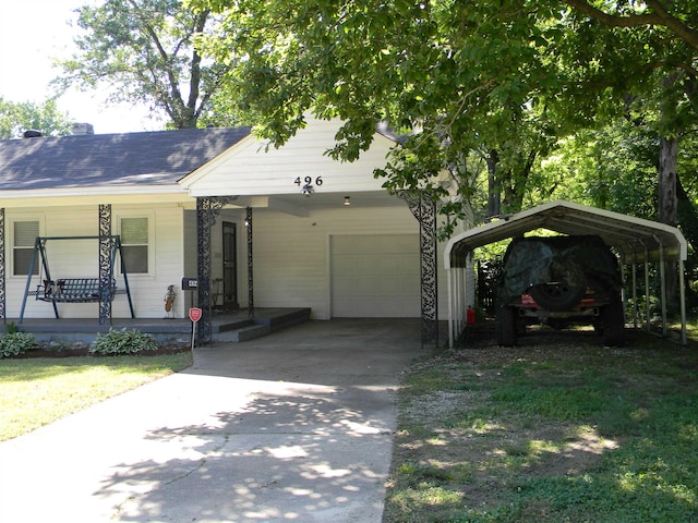 496 Eastern Dr SW, Memphis, TN 38122 - view of front facade with a porch, concrete driveway, a garage, and a carport