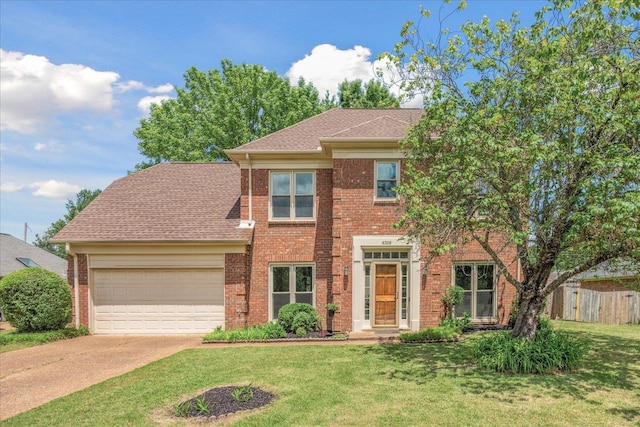 view of front facade with fence, an attached garage, brick siding, concrete driveway, and a front lawn