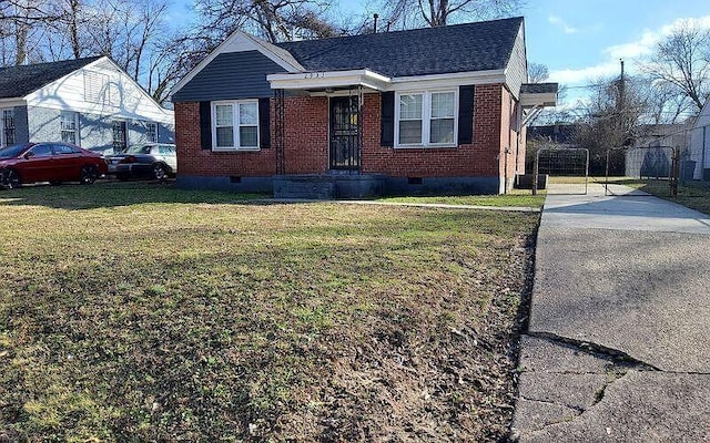 bungalow with fence, a front lawn, brick siding, and crawl space