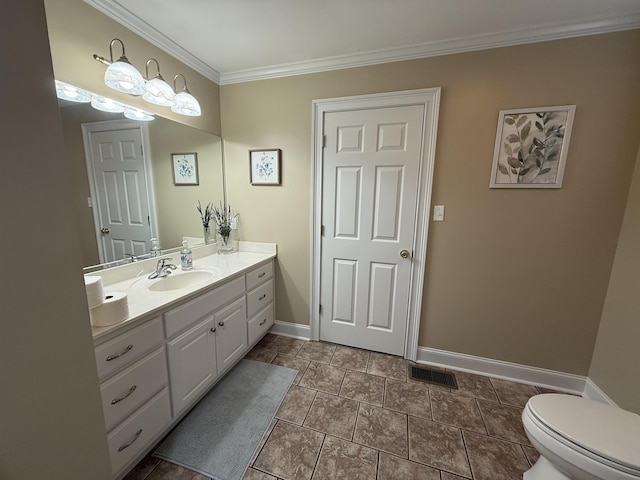bathroom featuring baseboards, toilet, visible vents, vanity, and crown molding