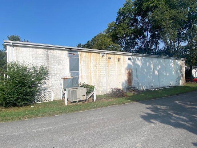 exterior space featuring central air condition unit and entry steps