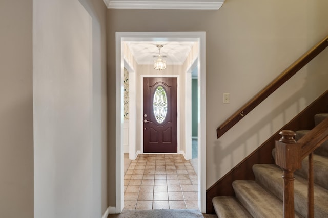 entryway with crown molding, stairs, a chandelier, and baseboards