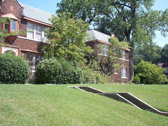 view of home's community with a yard