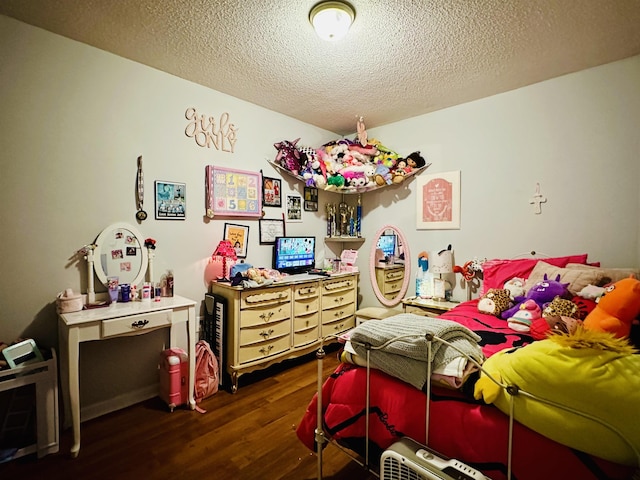 bedroom featuring a textured ceiling and wood finished floors