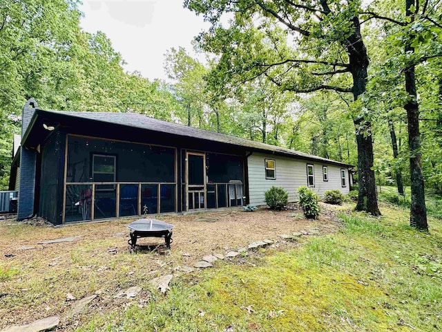 rear view of house featuring a sunroom