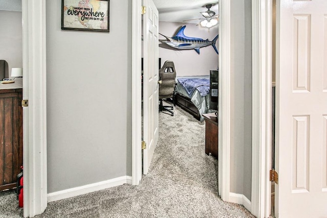 hall featuring light carpet and baseboards