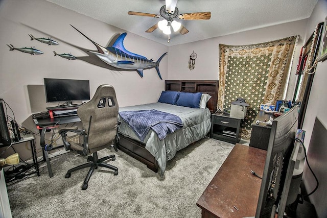carpeted bedroom featuring a textured ceiling and a ceiling fan