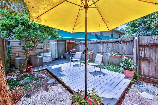 deck with central AC unit and a fenced backyard