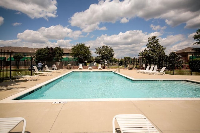 pool with fence and a patio