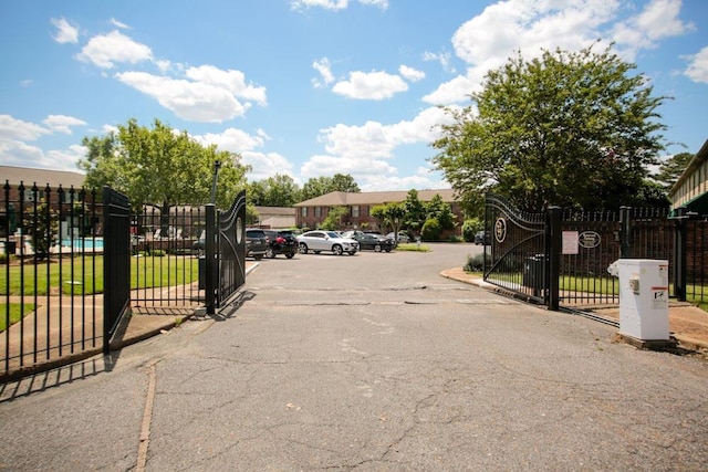 view of road with street lighting and a gate