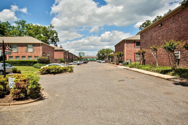 view of road featuring a residential view and curbs