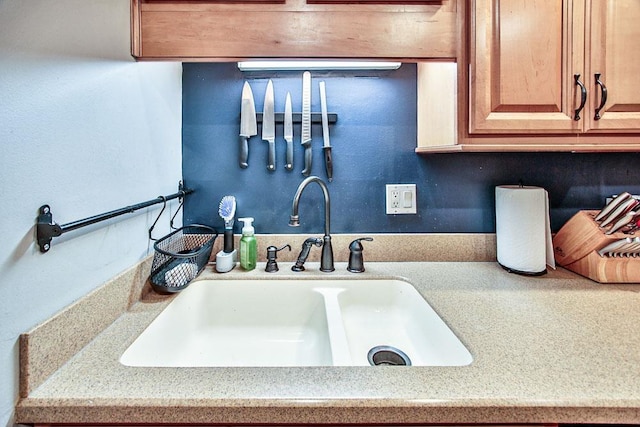 interior details featuring a sink and light countertops