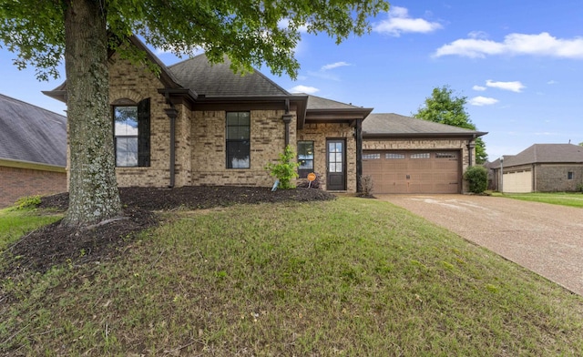 ranch-style house featuring roof with shingles, concrete driveway, a garage, and a front yard